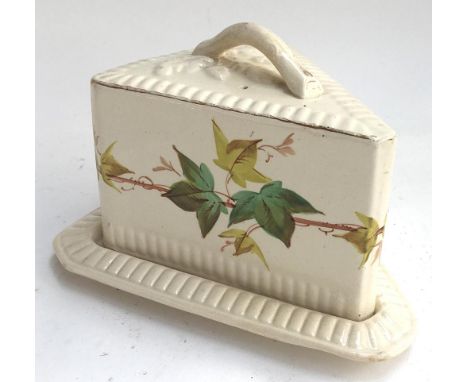 A ceramic wedge shaped cheese cloche, decorated with vine leaves, 15cmH 