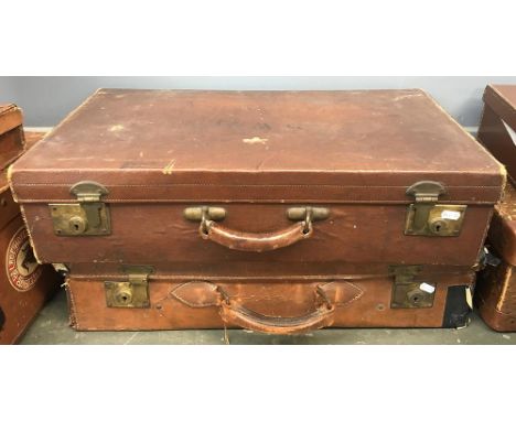 A vintage suitcase with brass fittings, the top monogrammed 'SWB', together with one other. 