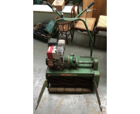 A Ransomes twenty-four rotary mower, with briggs and stratton 5hp engine, together with original grass collection box