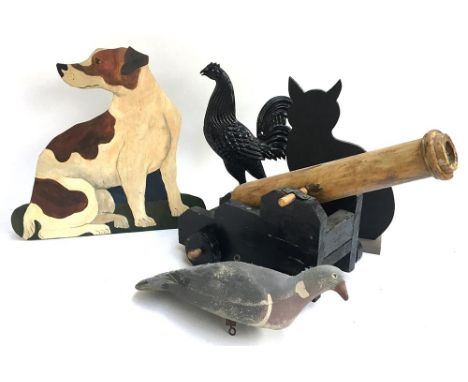 A wooden toy model cannon, together with a cat blackboard, metal cockerel silhouette, a vintage decoy pigeon and standing dog