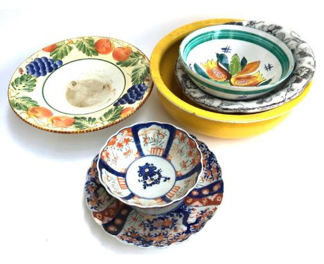 An Imari dish and bowl with scalloped edges, together with two fruit bowls, one other, and a large yellow enamel basin 