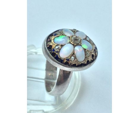 An early Victorian opal and diamond setting later converted to a ring, set with six oval opals in a floral design over pierce