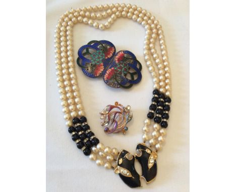 An art nouveau style enamelled brass belt buckle (as found), together with a Movitex orchid brooch and a simulated peal and b