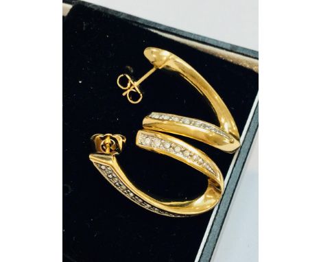 A pair of 9ct yellow gold wave design earrings, each set with 13 small stones. Total weight 7.8 grams. 