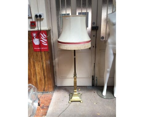 A brass lamp standard, the support of square section, with floral decoration and raised on down-swept square base, with cream