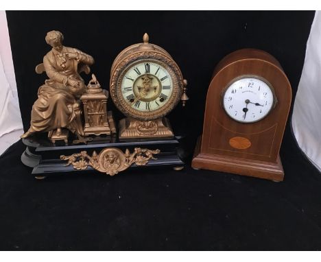 A 19th century gilt painted mantel clock, with a spelter cast figure emblematic of learning, the circular cased clock with wh