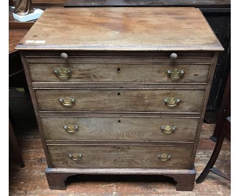 A George III faded mahogany four-drawer bachelor chest of drawers, with baize-covered brushing slide, brass handles and shape