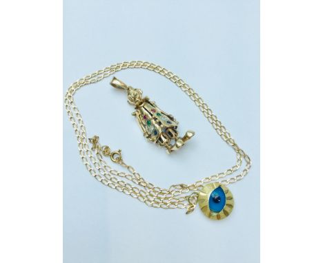 A mixed lot, consisting of a 14ct yellow gold EYE pendant suspended on a 9ct gold curb chain. Chain is 22 inches in length.  