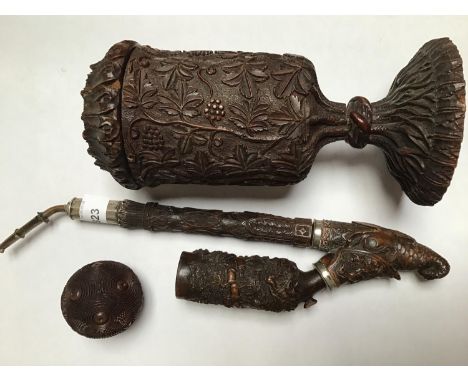 A Bavarian ornate wooden three-piece pipe, carved with scenes of hunting, and the base of the pipe carved as a fish with glas