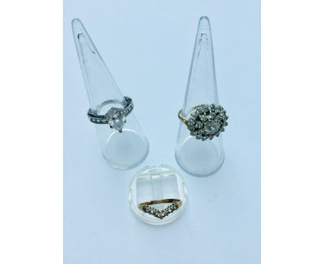 Three 9ct gold rings.  The white gold ring is set with a pear shaped stone weighs 3.7 grams, finger size N.  The cluster ring