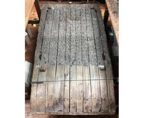 A Spanish 'Threshing Board' tilling plough converted to a table, the planked top inset with lithic flint flakes and lengths o