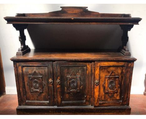 A late 19th century stained oak Gothic Reform two-tier buffet, with a pair of base cupboard doors, 138cm wide 