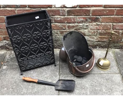 A copper coal scuttle together with a black wrought iron umbrella / stick stand and a loaded brass door stop 