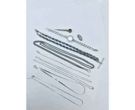 An assorted lot of silver jewellery, including seven silver chains, two brooches and a silver hallmarked Gems K wristwatch wi