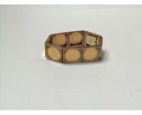 An unusual 9ct gold bracelet formed from eight square links, each set with 22ct gold 1 Rand coins, 5 x 1971 and 3 x 1972, gro