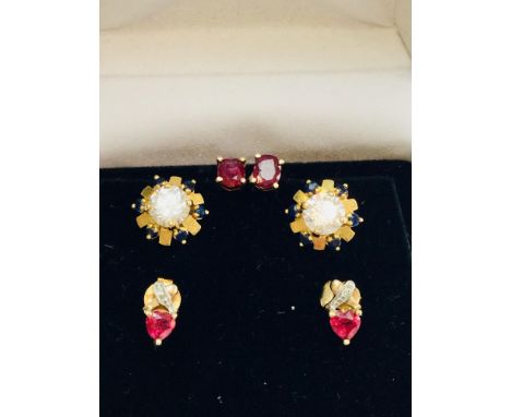 An assorted lot of 9ct gold earrings, consisting of 2 pairs set with rubies and 1 pair set with sapphires and white stones.  