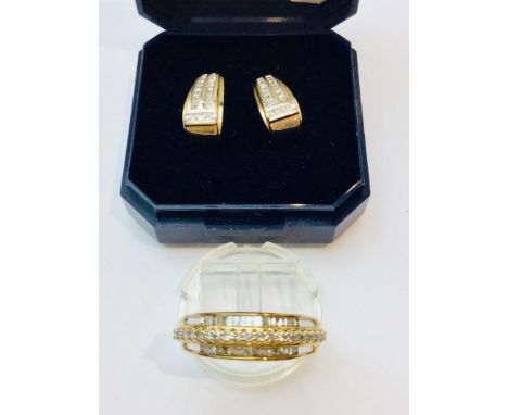 A 9ct gold dress ring set with baguette and round brilliant cut diamonds in a channel and claw setting. Estimated weight of d