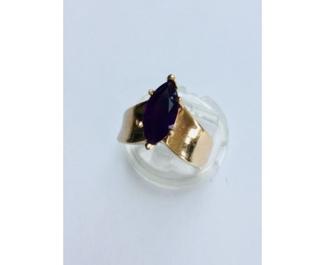 Two yellow gold Amethyst dress rings.  The 9ct gold oval shaped amethyst is in a rub over heart design setting, finger size K