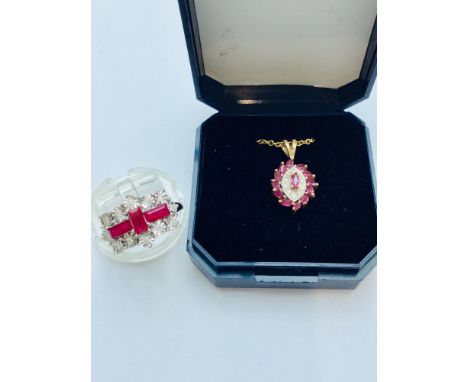 A ladys 9ct yellow gold ruby and diamond dress ring, set with 3 x baguette cut rubies to the centre surrounded by 12 x small 