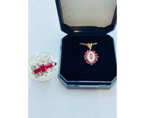 A ladys 9ct yellow gold ruby and diamond dress ring, set with 3 x baguette cut rubies to the centre surrounded by 12 x small 