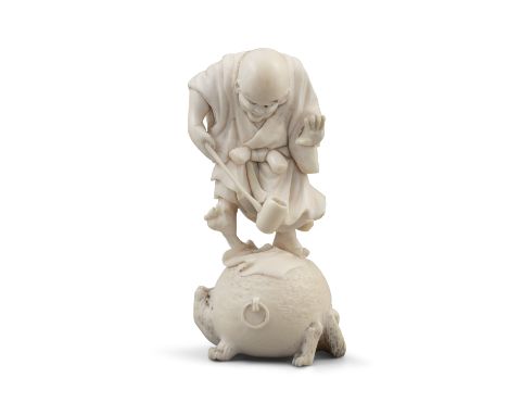 *A CHARMING IVORY OKIMONO OF A MONK STANDING ON A TANUKI KETTLE Japan, 19th century H: 9,5 cm Weight: 108 grams  Provenance: 