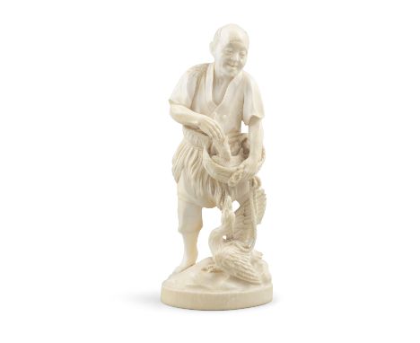 *AN IVORY OKIMONO OF A MAN WITH A BASKET FISH AND A CORMORAN Japan, Meiji period With signature to the below maybe reading Ha