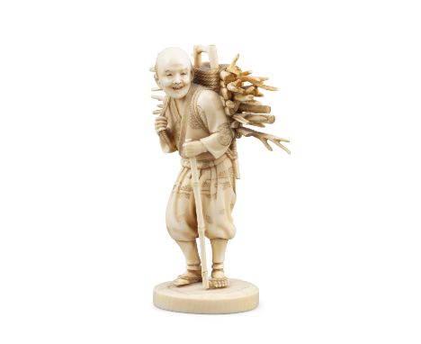 *A SIGNED IVORY OKIMONO OF A PEASANT HOLDING A BUNDLE OF WOOD Japan, Meiji period The below inlaid with a red lacquer rectang