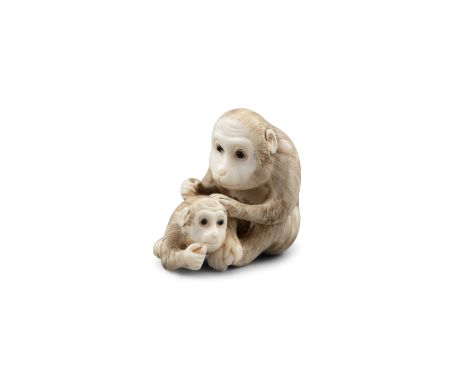 *TOMOKAZU友一: AN IVORY 'TWO MONKEYS' KATABORI NETSUKE Japan, Kyoto, Edo period Pierced with two himotoshi. With signature Tomo