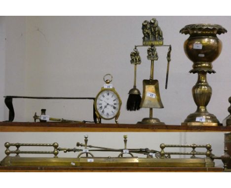 A collection of brass ware including fire kerb, fire irons, companion set, mantle clock, copper trivet, etc.