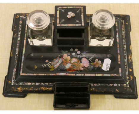 An Edwardian papier mache pen stand with inset mother of pearl decoration together with a black lacquered papier mache snuff 