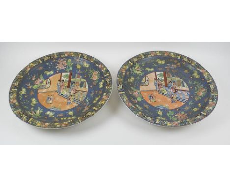 ORIENTAL CERAMIC CHARGERS, two similar, each decorated a central figurative scene surrounded by borders of birds, floral and 