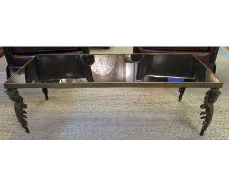 LOW TABLE, French 1970's in the manner of Maison Jansen, black glass top over brass frame and cast bronze figurehead supports