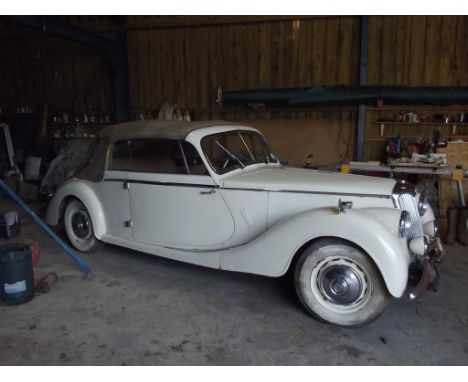 A 1951 Riley RMD drop head coupé, registration number 318 XUU, old English white. Riley's RMD is a very rare beast, with only