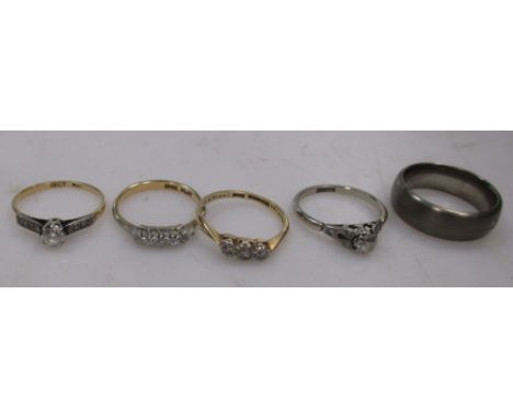 Four diamond set rings together with a titanium wedding band (5)  