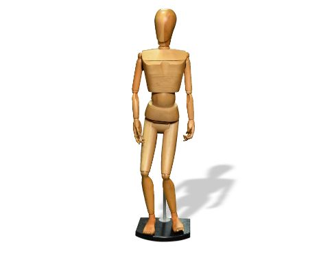 A 20th century carved wood full size mannequin, with articulated joints, mounted to a telescopic supporting rod on ebonised p