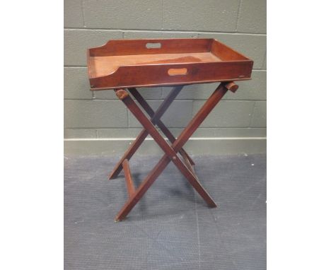 A mahogany butlers tray with folding stand  