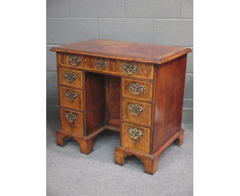 An 18th century walnut kneehole desk on bracket feet 75 x 83 x 53cm