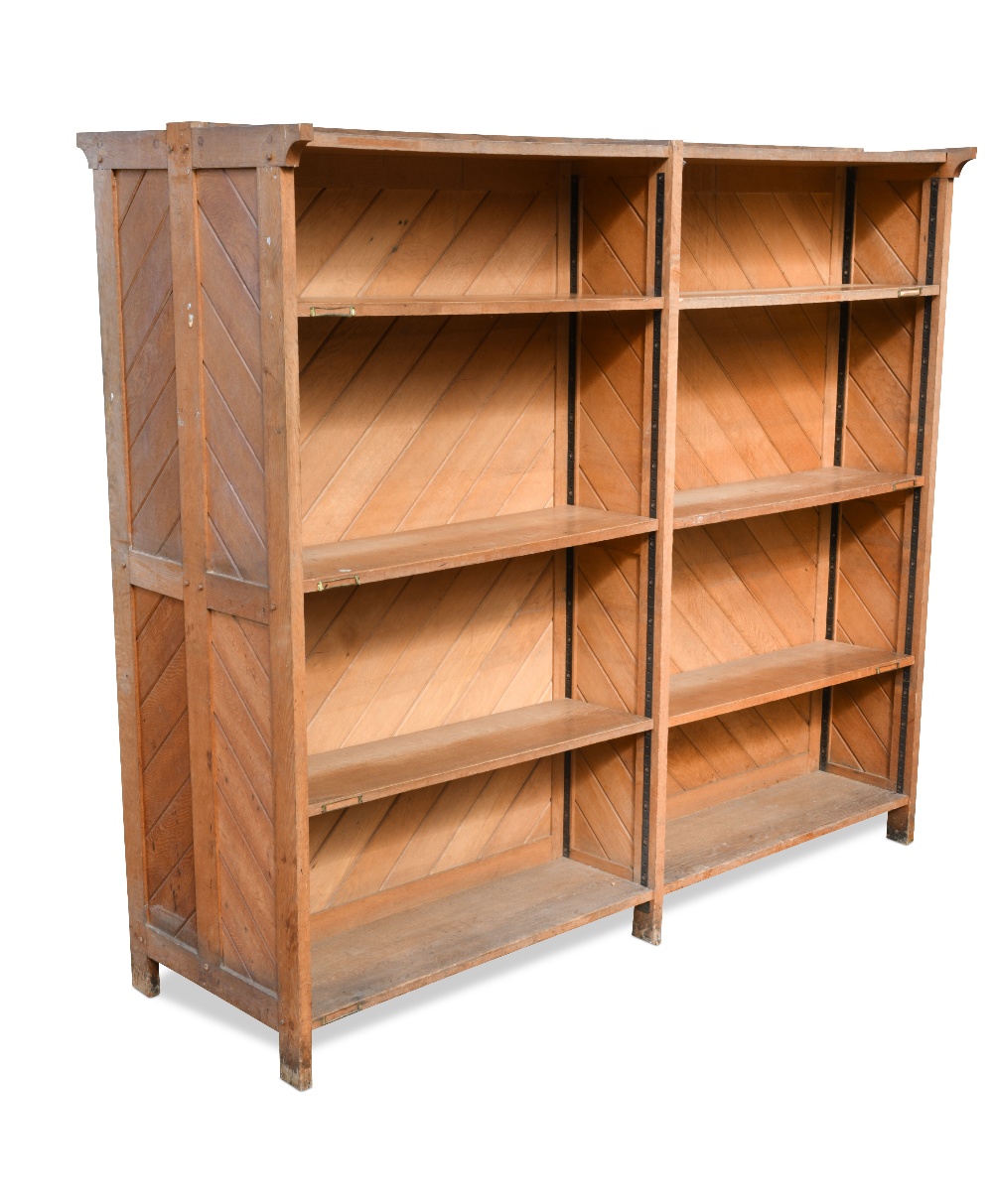 A late 19th century oak double sided bookcase, each side with two