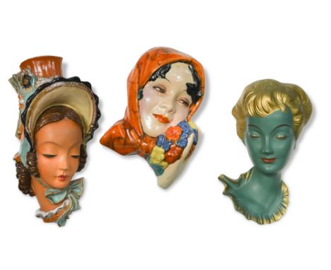 Three Art Deco Goebel wall masks, two in painted terracotta, the other in painted plaster, impressed marks (3)  The girl with