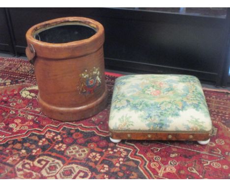 A Victorian walnut footstool and a leather ammunition carrier waste-bin  