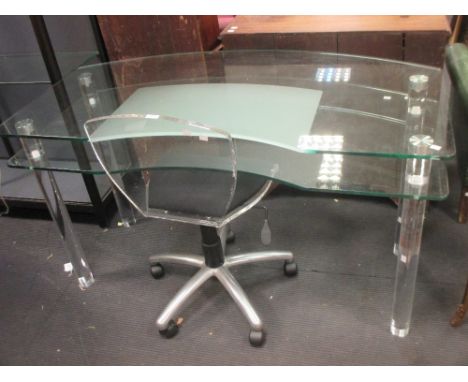 A contemporary glass topped desk on acrylic cylindrical legs, together with a plexiglass swivel chair and a table easel  