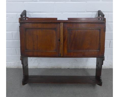 Mahogany wall cabinet with a pair of cupboard doors above a single shelf, with Gothic pierced motifs to the side supports,  5