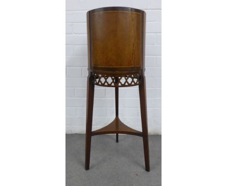 Mahogany cylindrical planter / wine cooler, with a lead lined interior, pierced frieze and three splayed legs, (a/f with loss