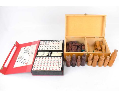 A cased carved wooden chess set, and a cased mahjong set (2).