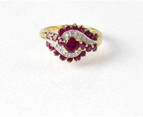 A 9ct yellow gold dress ring set with central ruby and smaller rubies, with central illusion set diamond chips, stamped '375'