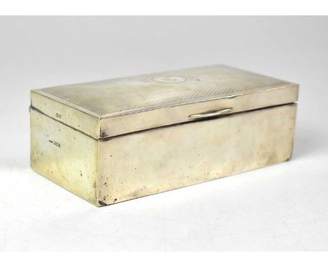 A George V hallmarked silver cigarette box with wooden liner, London 1922, engine turned decoration with initial 'D' to the l