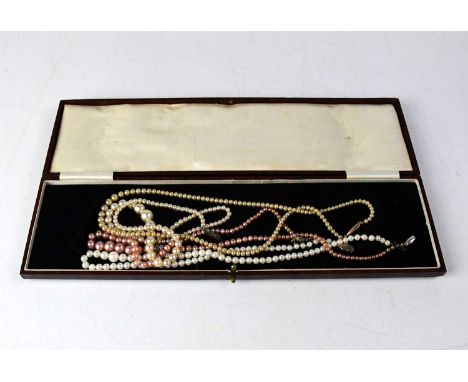 A graduated pearl necklace with a silver and marcasite clasp, length 40cm, together with three faux pearl necklaces, one with