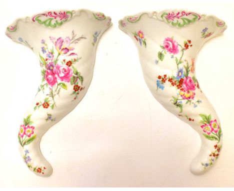 ROYAL WORCESTER; a pair of porcelain floral decorated wall pockets in the form of cornucopias, made for Compton &amp; Woodhou