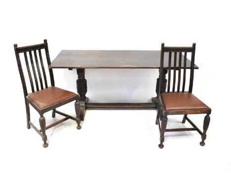 An early 20th century oak dining room suite comprising a dresser with boarded plate rack and three thick shelves above three 