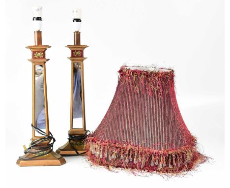 A pair of mirrored and painted wooden table lamps, with beaded fringed burgundy shades, height of bases 48cm (2).